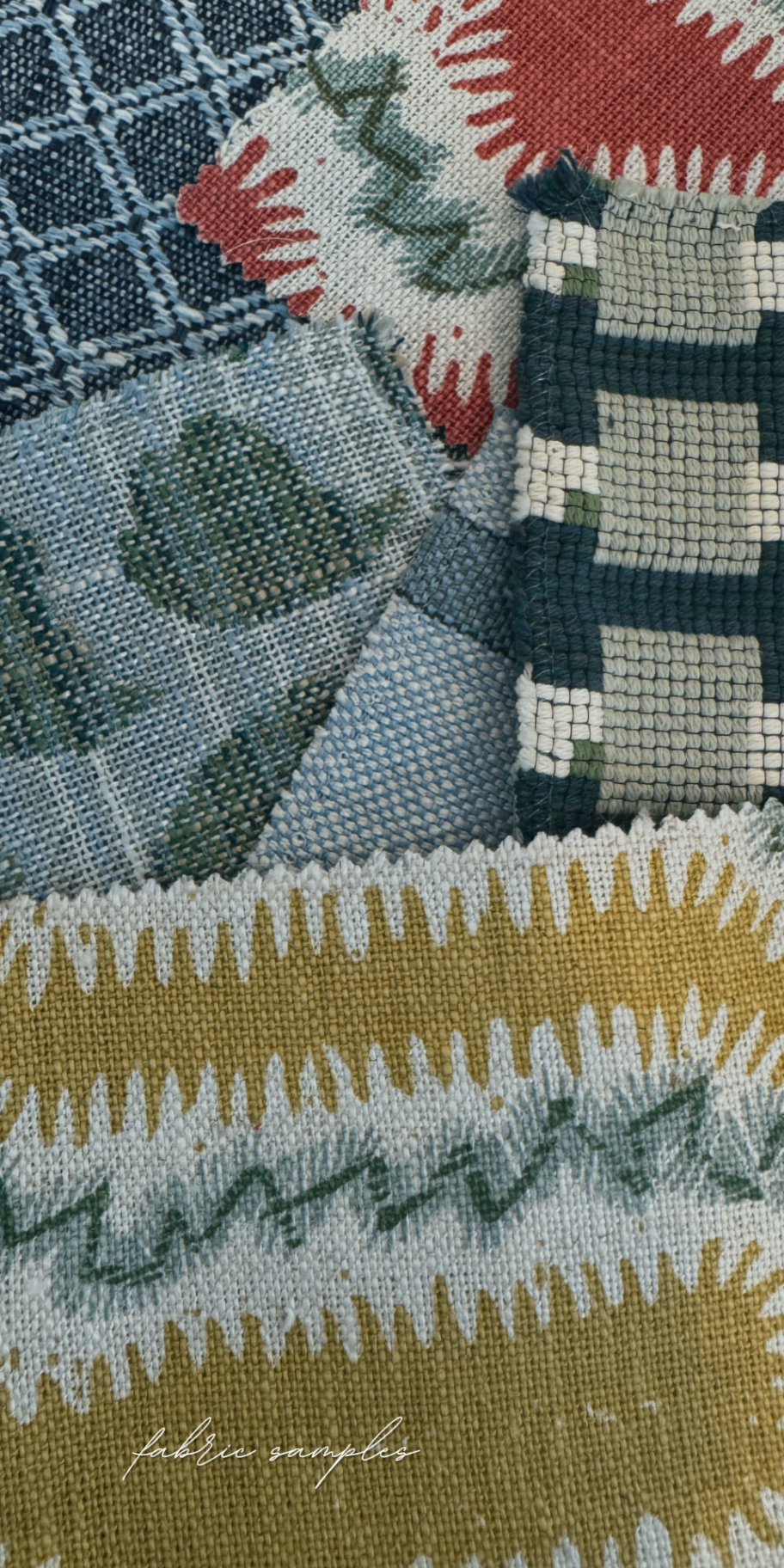 Fabric samples layered over patterned upholstery textile