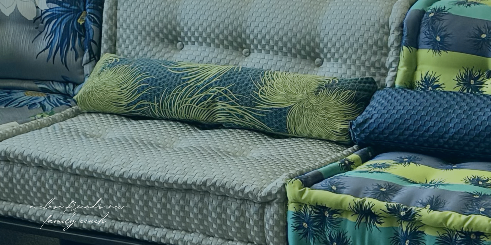 Pattern-rich family couch with layered blue and green pillows